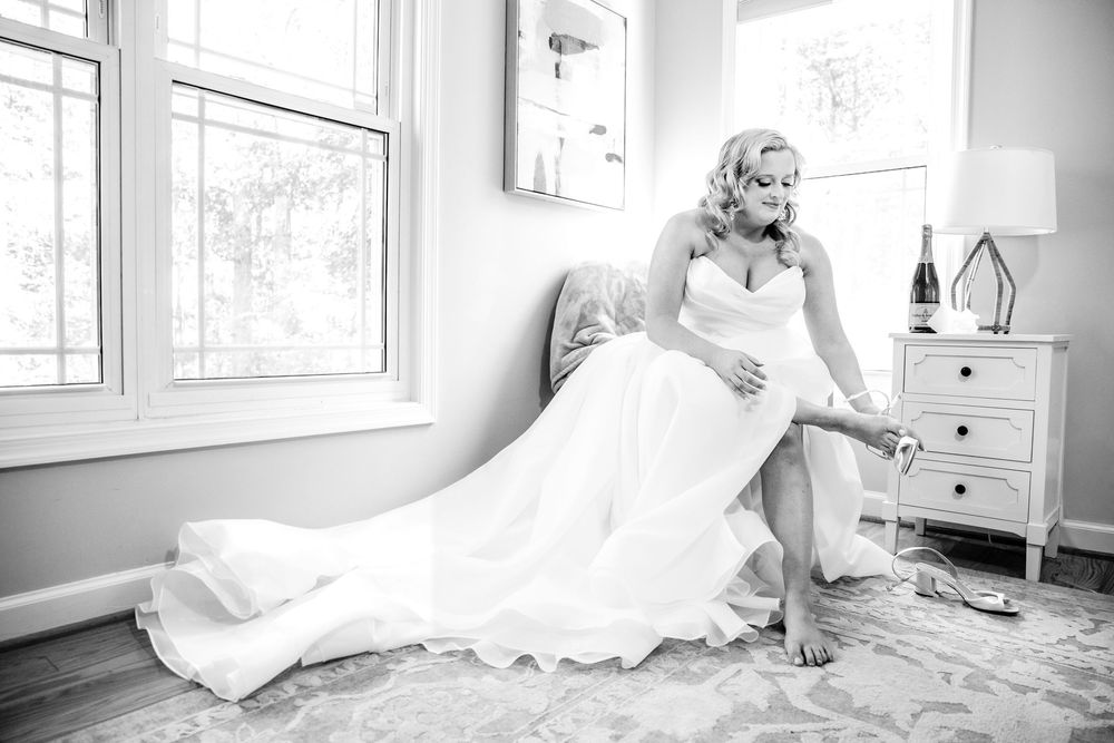 Sunlit room with white wedding dress and natural window light.