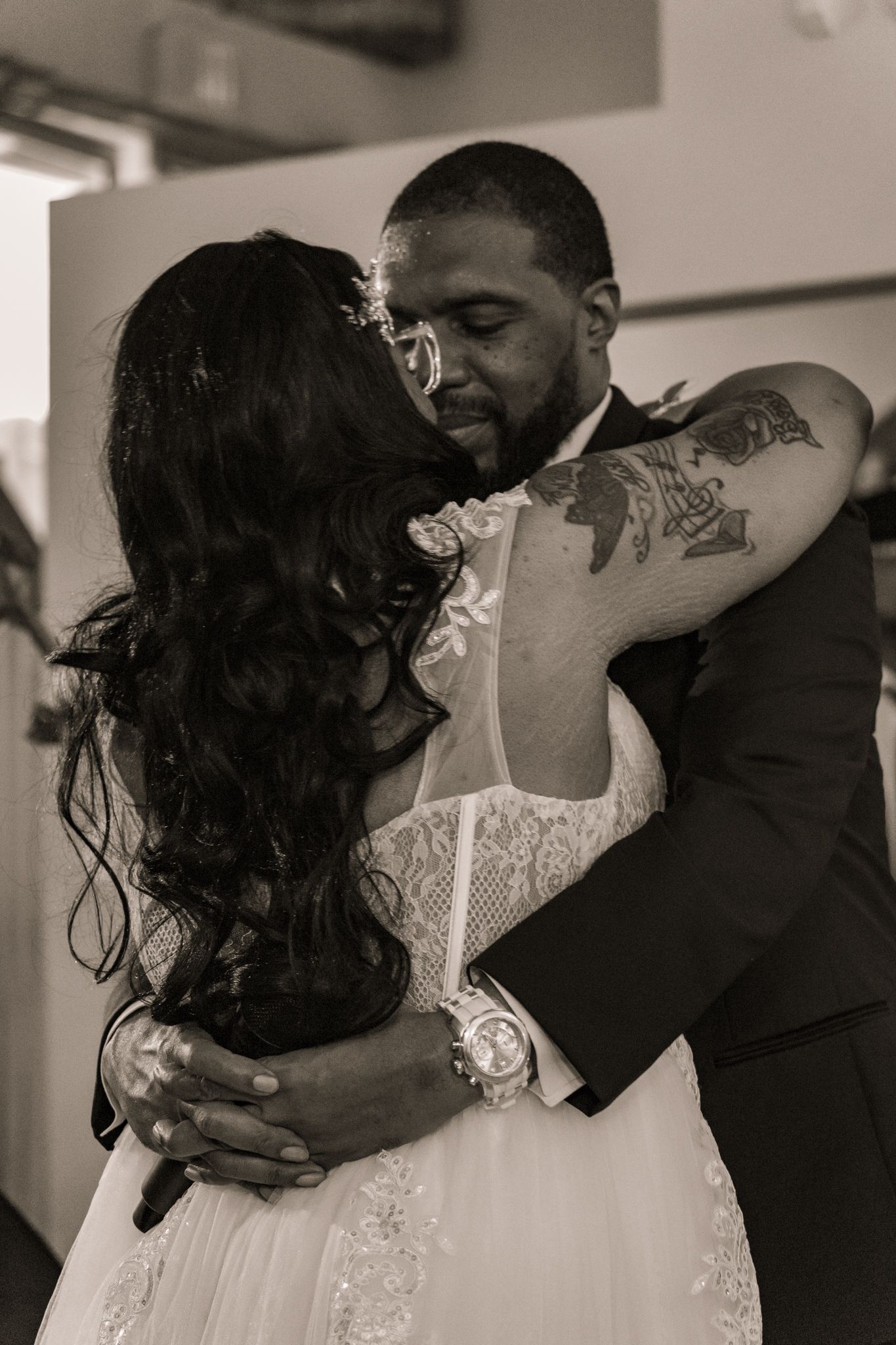 Black and white wedding photos showing intimate moments between couple in formal attire.