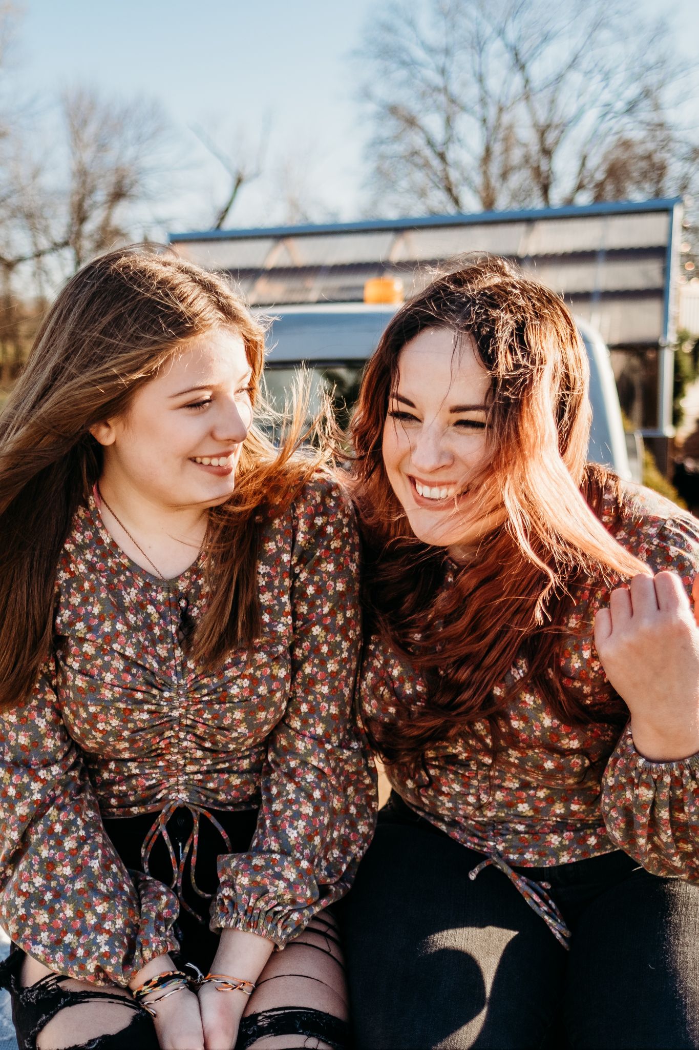 Two girls are laughing together in a family photography session in Northwest Arkansas