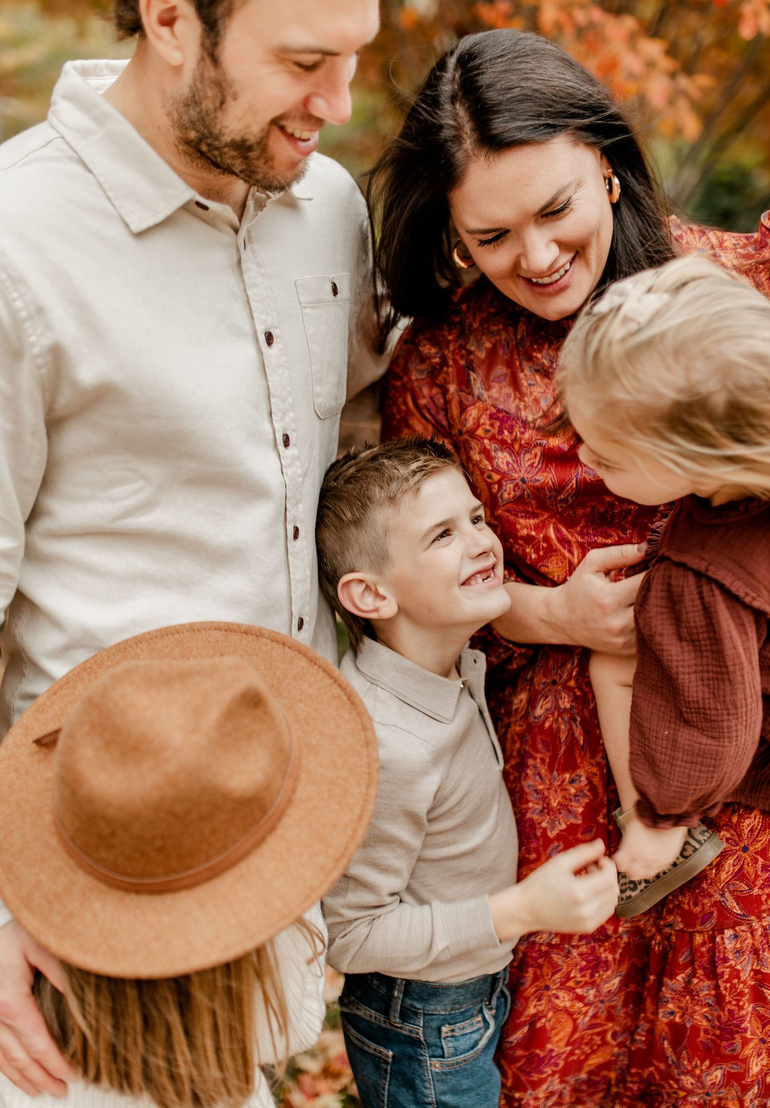 Family sharing joyful moment together during fall photo session.