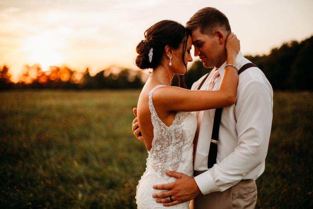 Couple holding each other with their foreheads together in sunset light