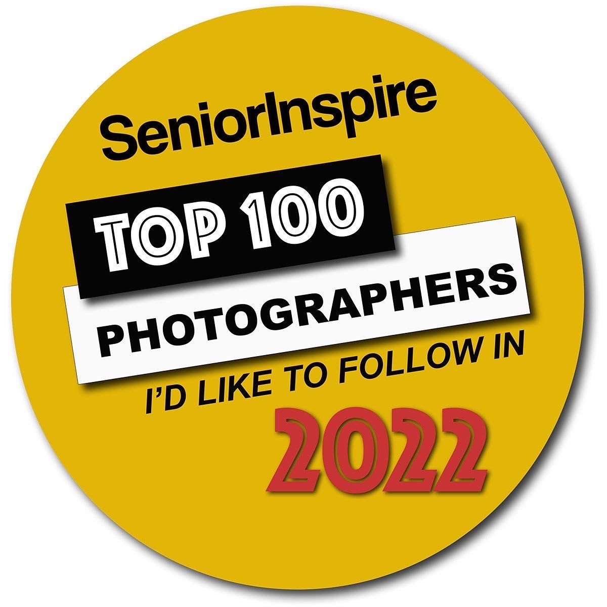 Yellow circular badge for SeniorInspire Top 100 Photographers to follow in 2022.
