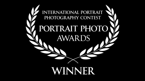 Black and white laurel wreath logo for International Portrait Photography Contest winner.