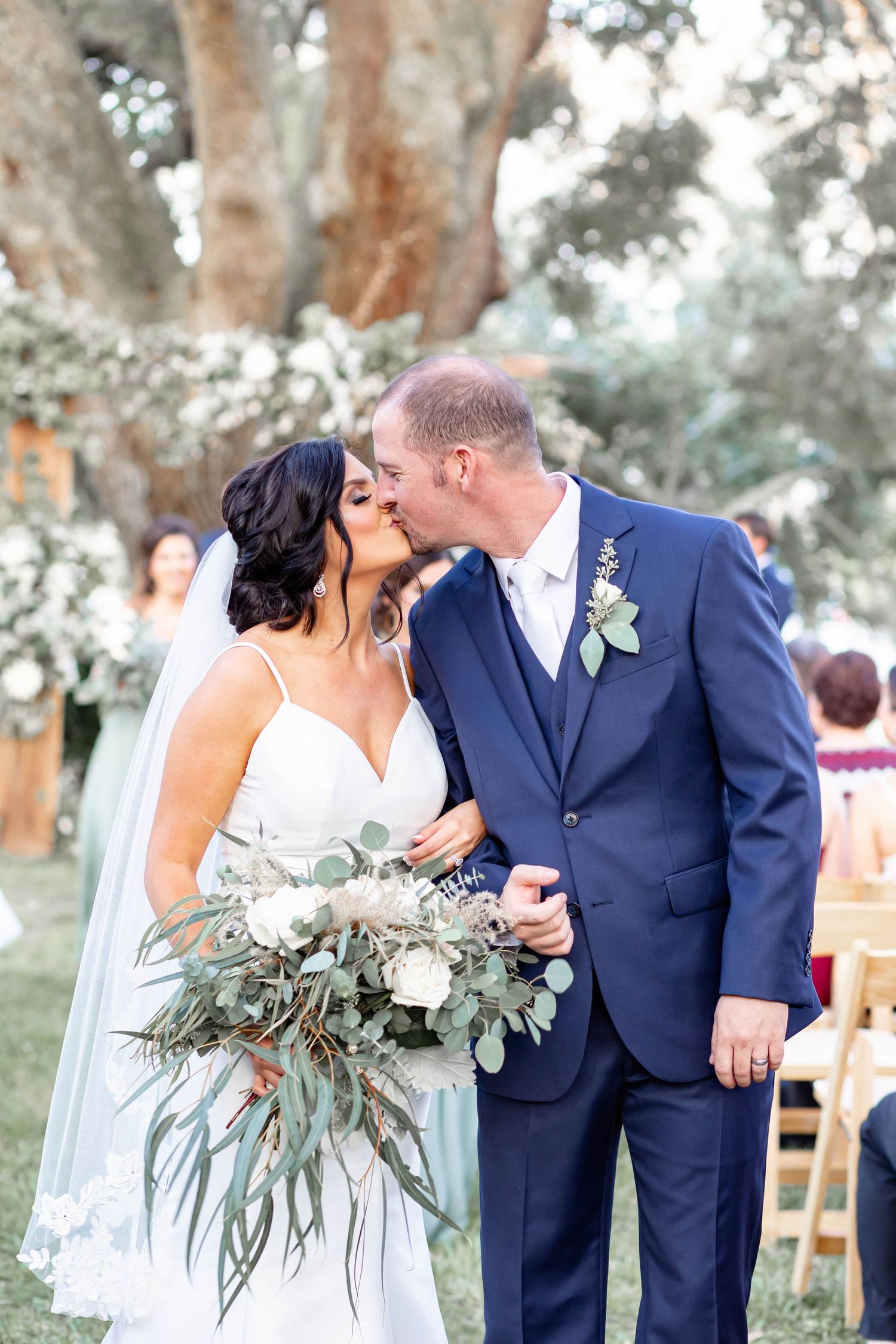 bride and groom kiss down the aisle