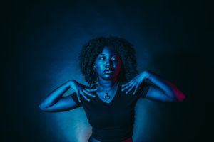Artistic portraits with dramatic neon lighting creating moody silhouettes against dark background.