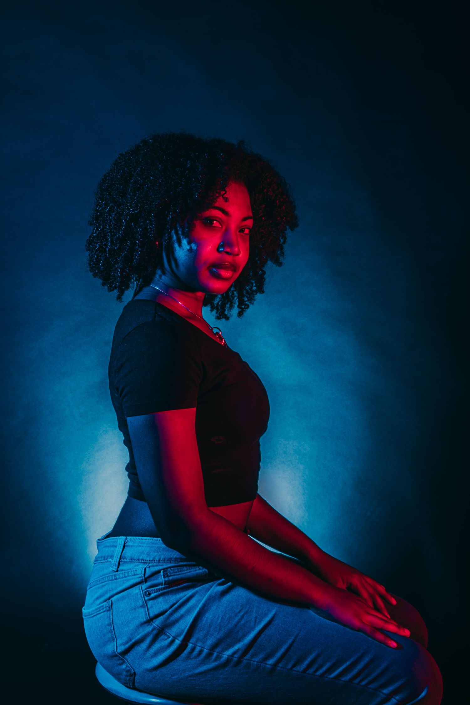 Artistic photo series featuring dramatic poses illuminated by contrasting blue and red lighting.