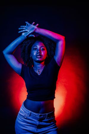Contemporary portrait series featuring dynamic poses and dramatic colored lighting effects.