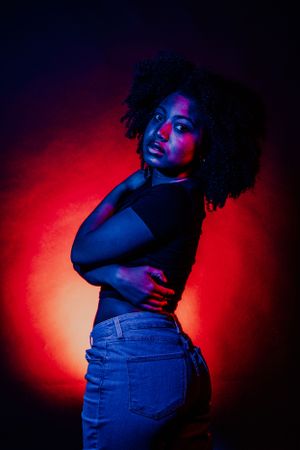Expressive dance-like poses captured in moody red and blue lighting showing movement and form.
