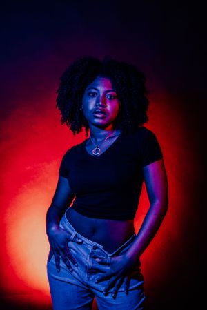 Artistic portrait series with model in denim and black top under dramatic colored lighting effects.