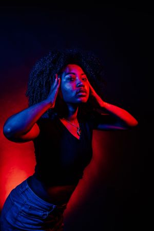 Expressive portrait series with red and blue lighting effects creating dramatic shadows.