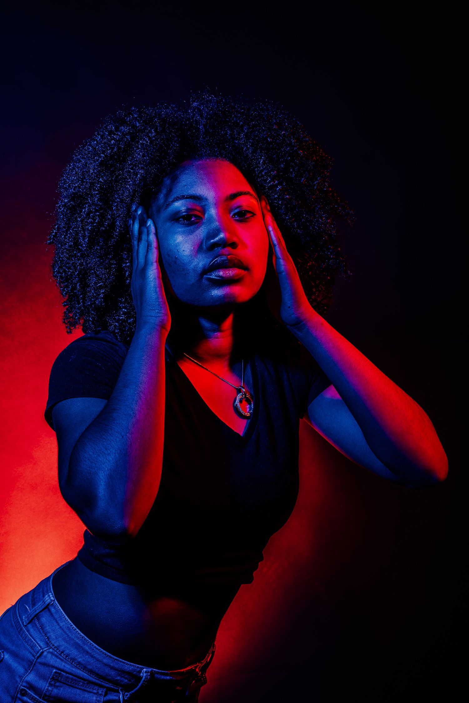 Artistic headshots with vibrant red and blue lighting creating atmospheric mood.