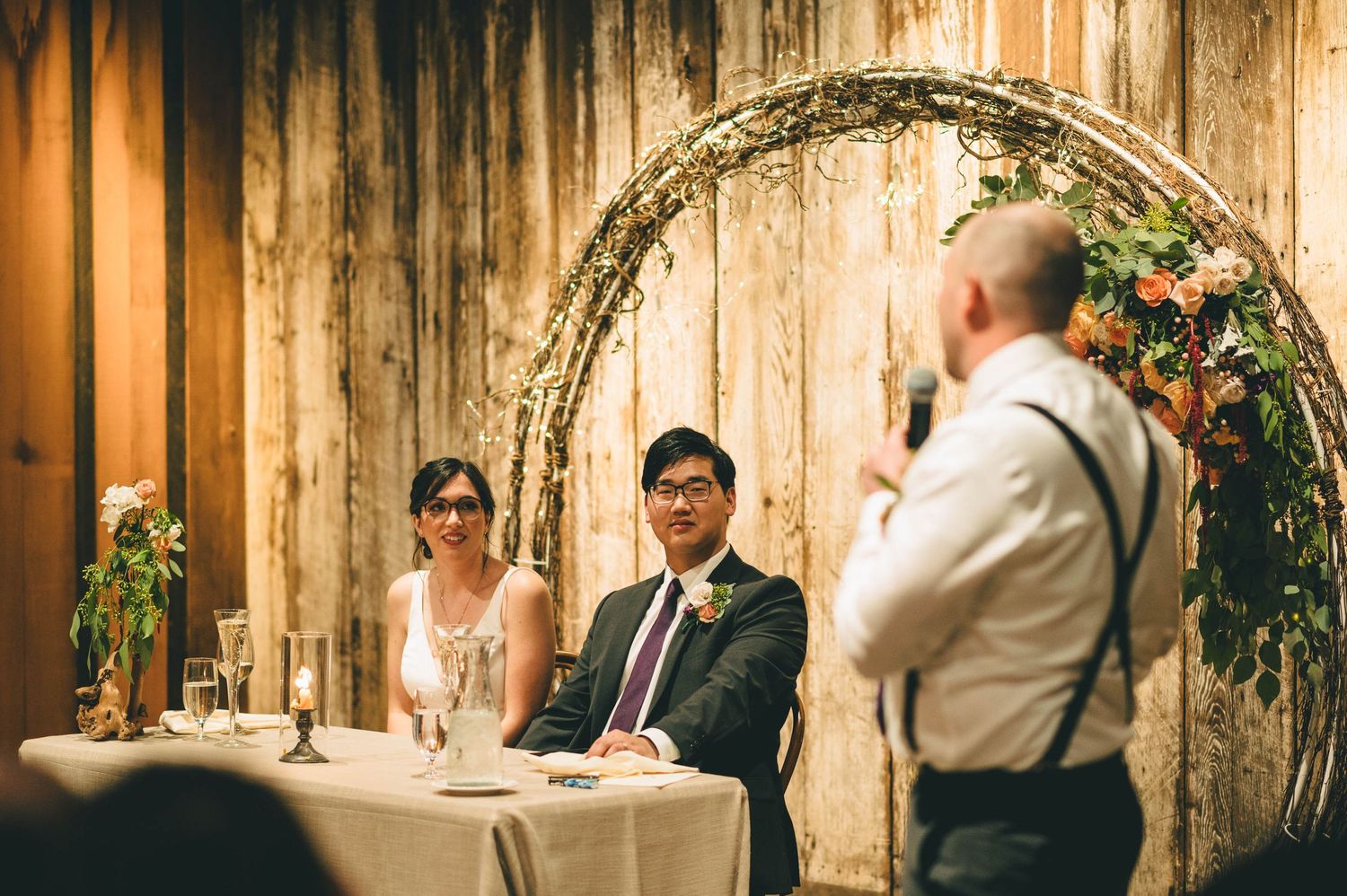groom listening to the speech from his best man