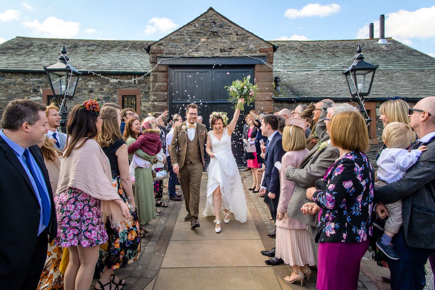 Confetti exit after barn wedding at New House Farm in Cumbria