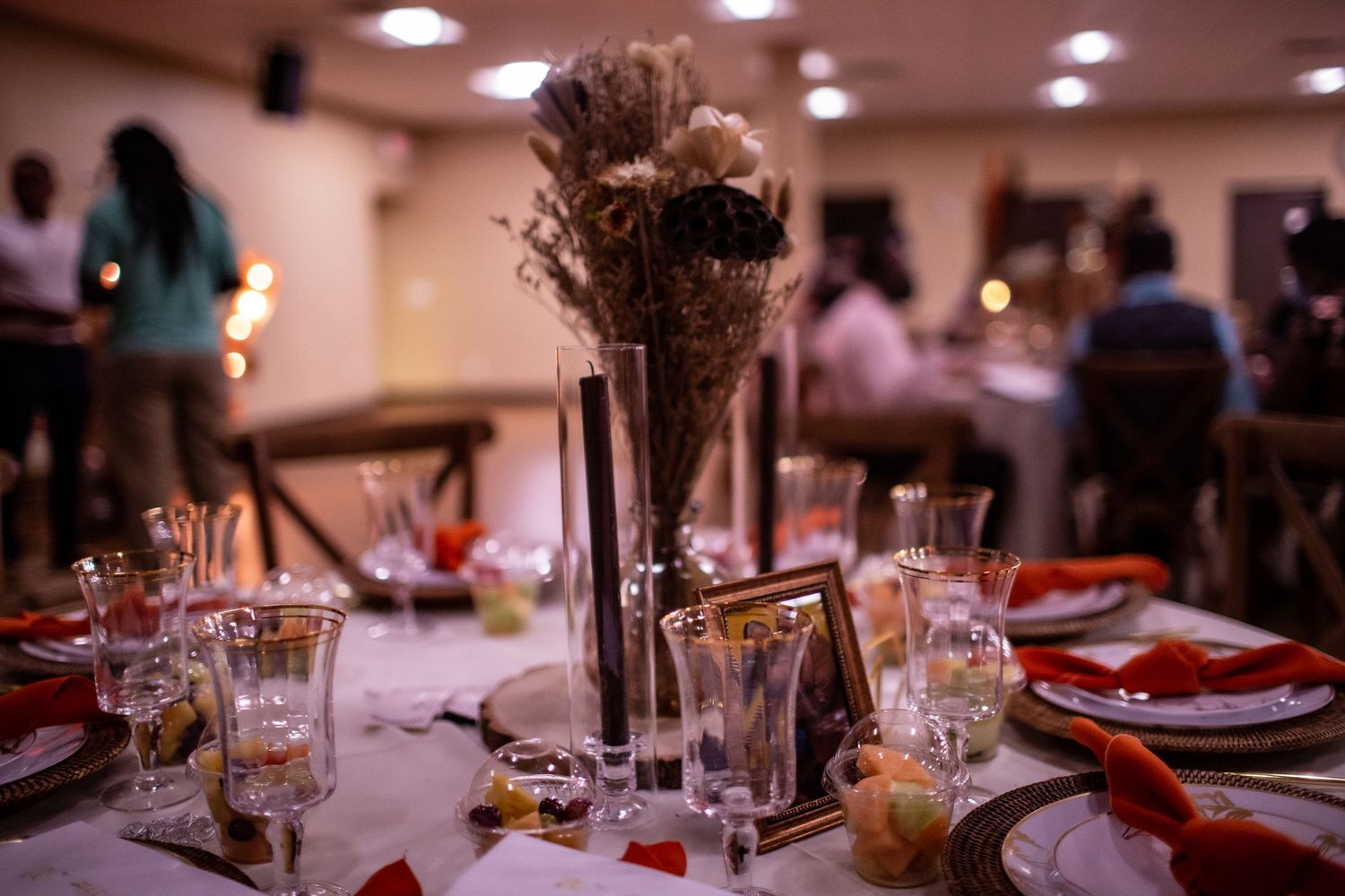 Elegant table setting with centerpiece and glassware at formal event.