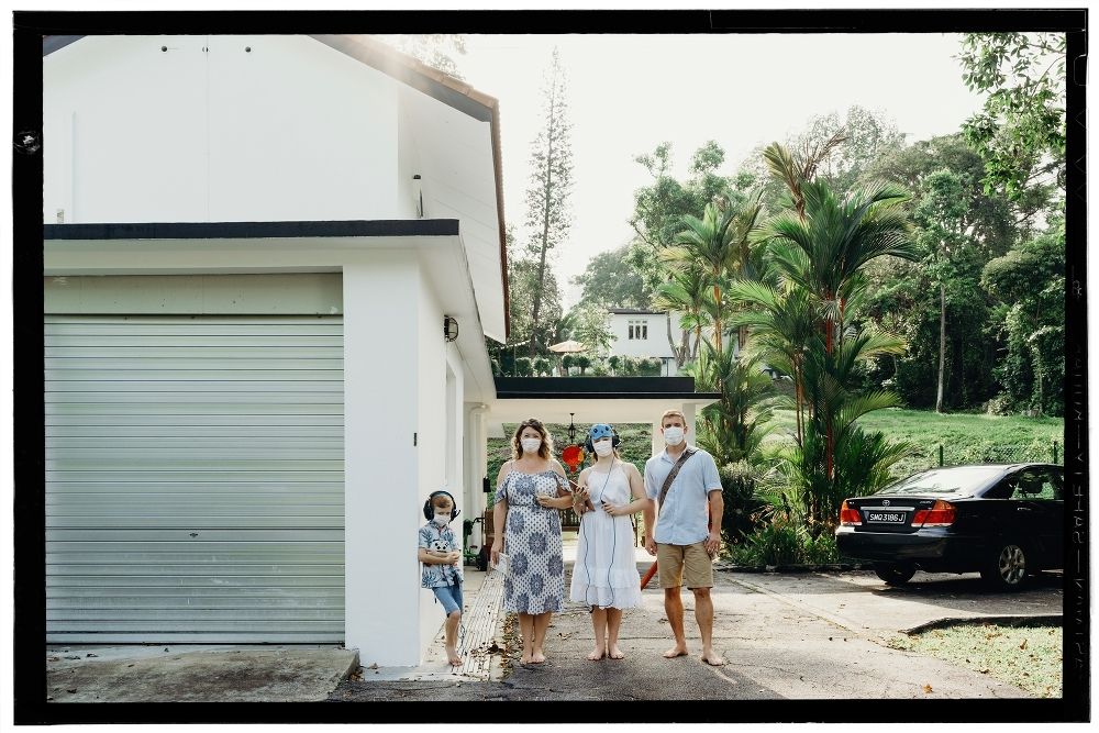 A family of four outside their home wearing masks in Singapore