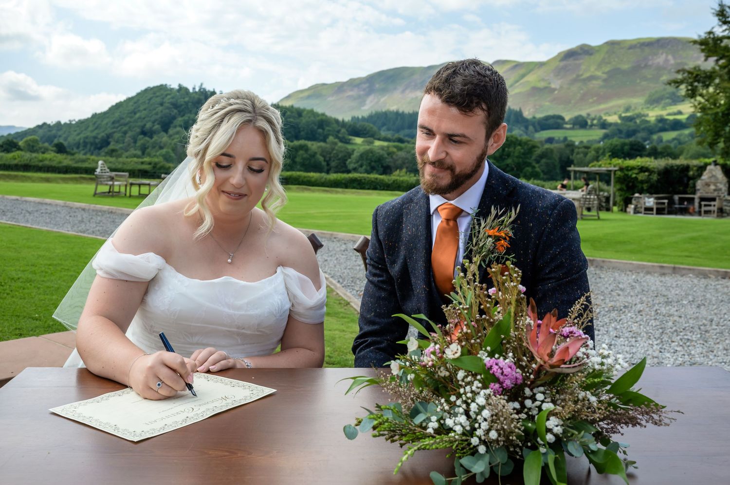 Newlyweds signing certificate at New House Farm wedding