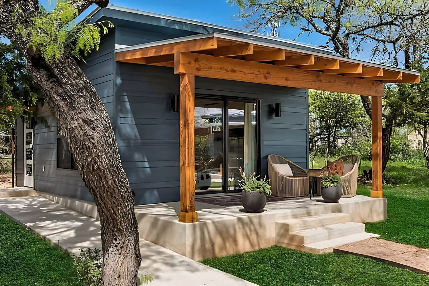 New construction backyard patio with custom wooden pergola and modern landscaping in the Hill Country.