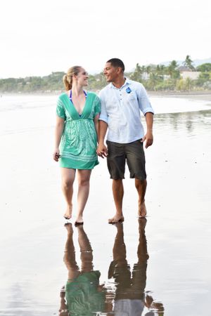 Engaged couple walking on a beach