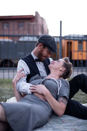 Engaged couple kissing in a trainyard