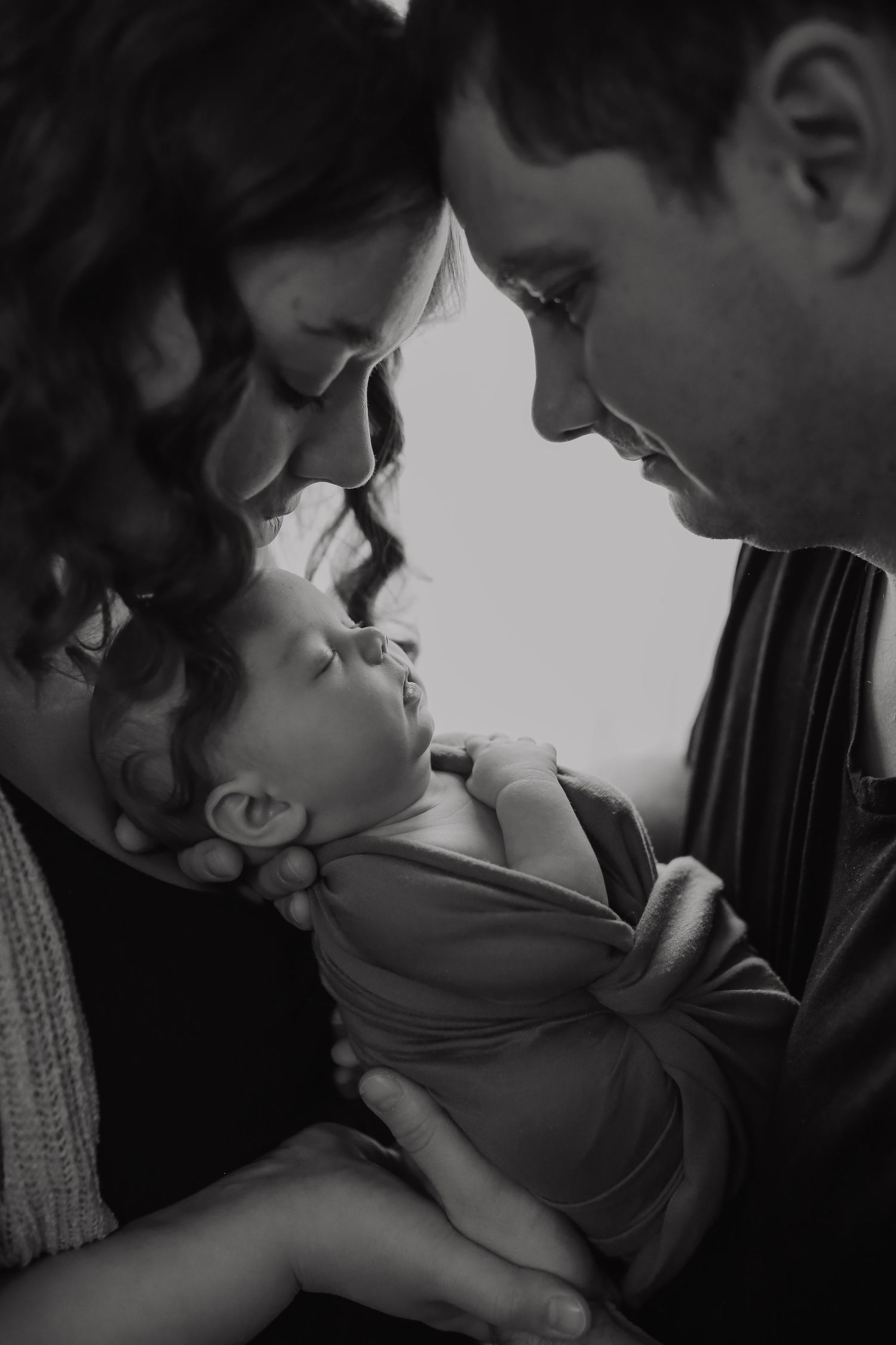 Intimate black and white portrait series capturing tender romantic moments between a couple.