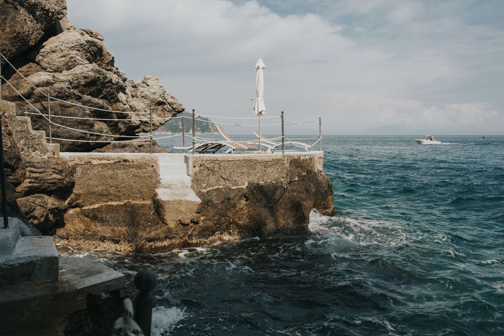 A sun deck at the base of a cliff at a wedding venue in Amalfie Coast, Italy.
