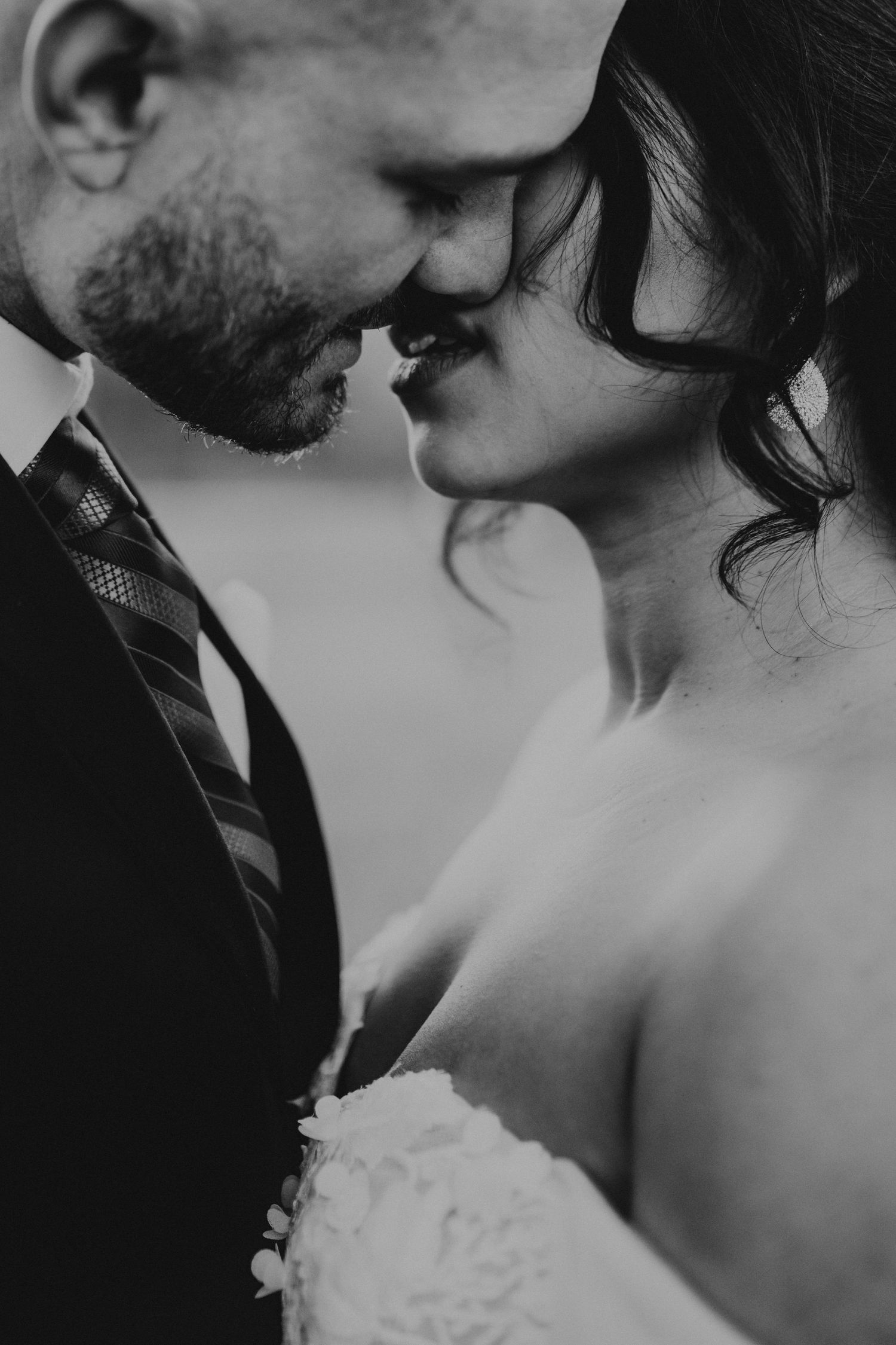 A romantic black and white close-up photo of a couple sharing an intimate moment.