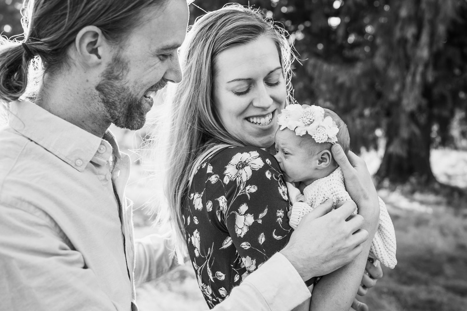 Black and white photo of parents comforting crying newborn baby