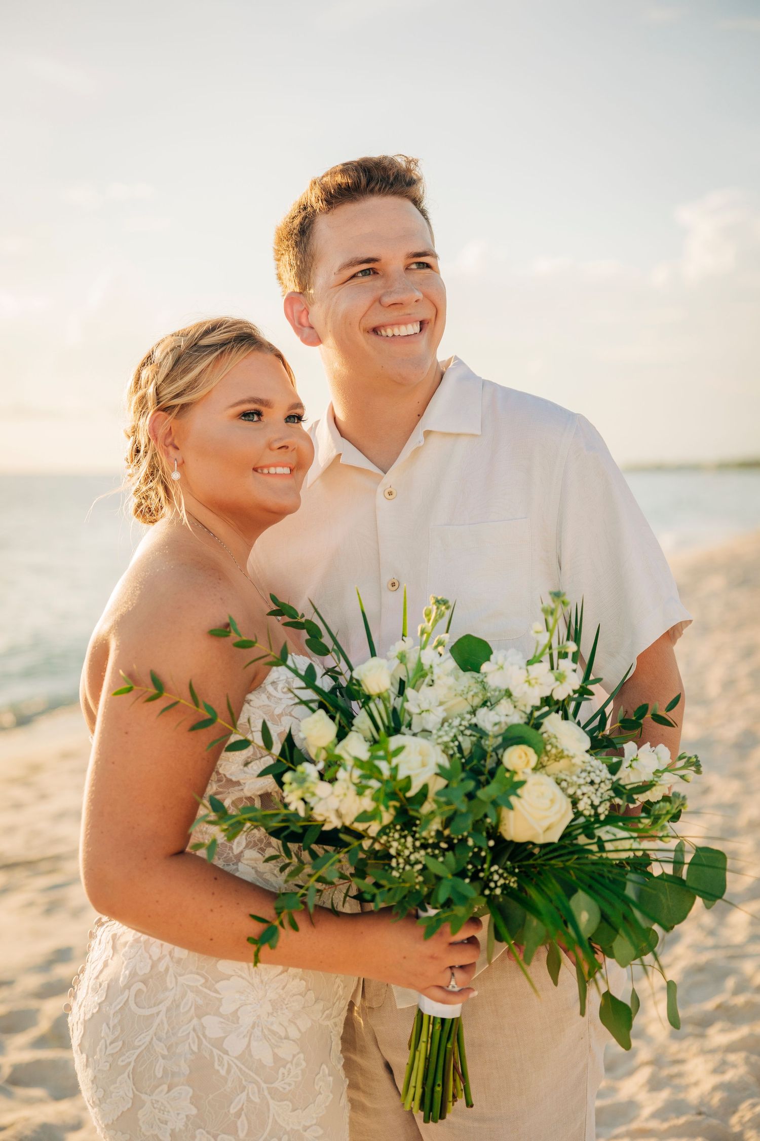 Bridal portraits at sunset on Siesta Key Beach after wedding ceremony taken by Sarasota Wedding Photographer.