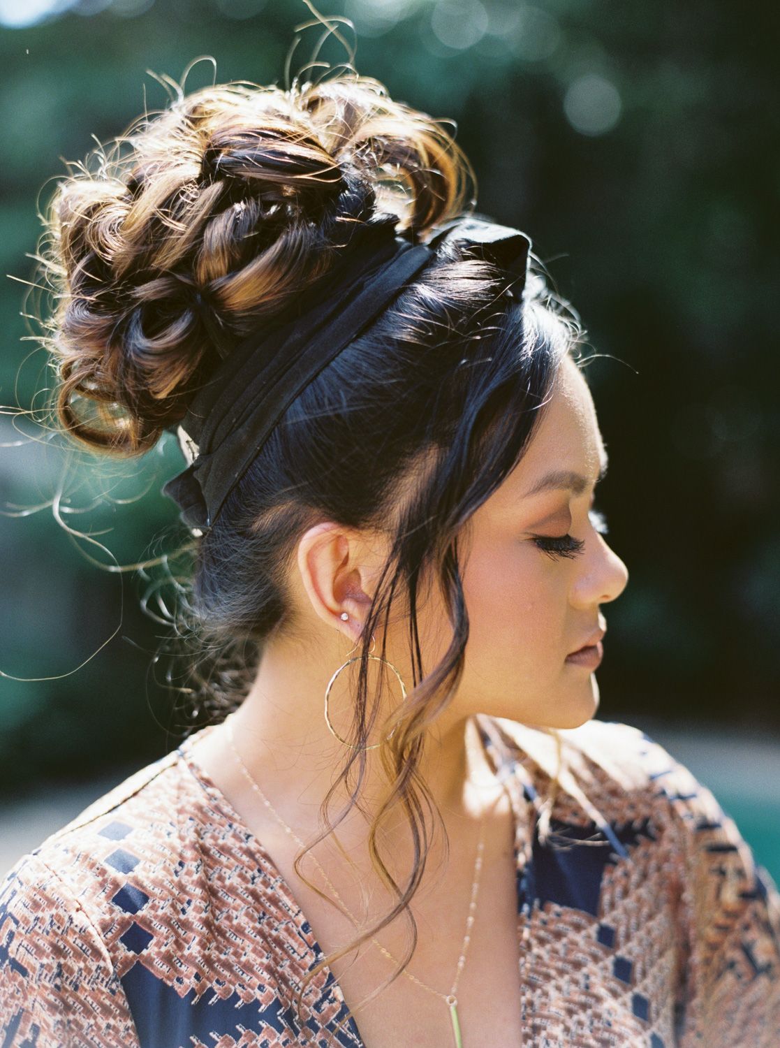 Close up of model with updo hair and eyes closed