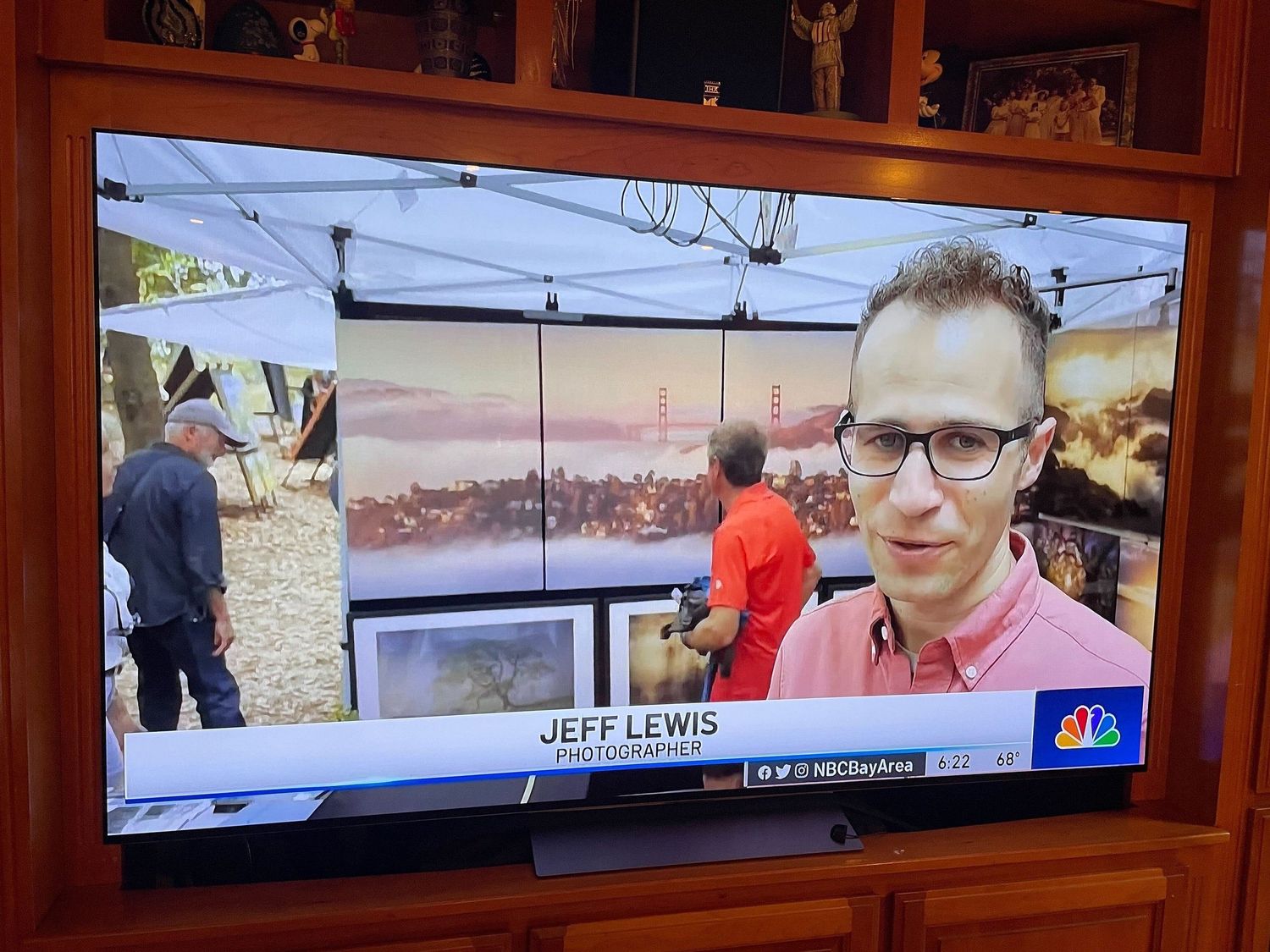 A news broadcast segment shows a reporter in a pink shirt during an outdoor event with photos displayed in the background.