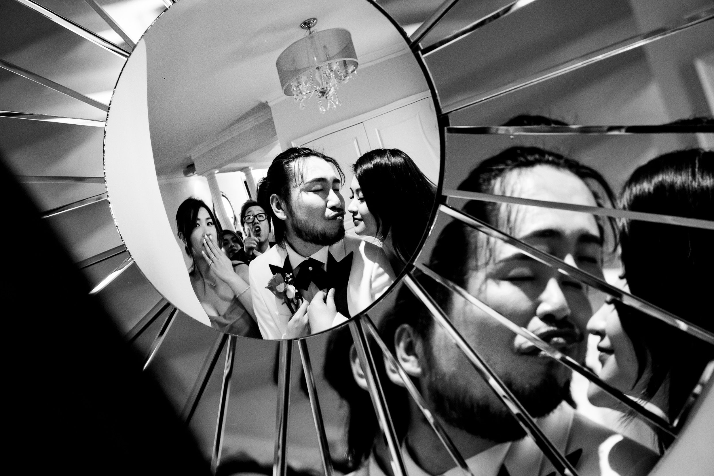 Artistic black and white reflection in broken mirror pieces creating multiple angles.