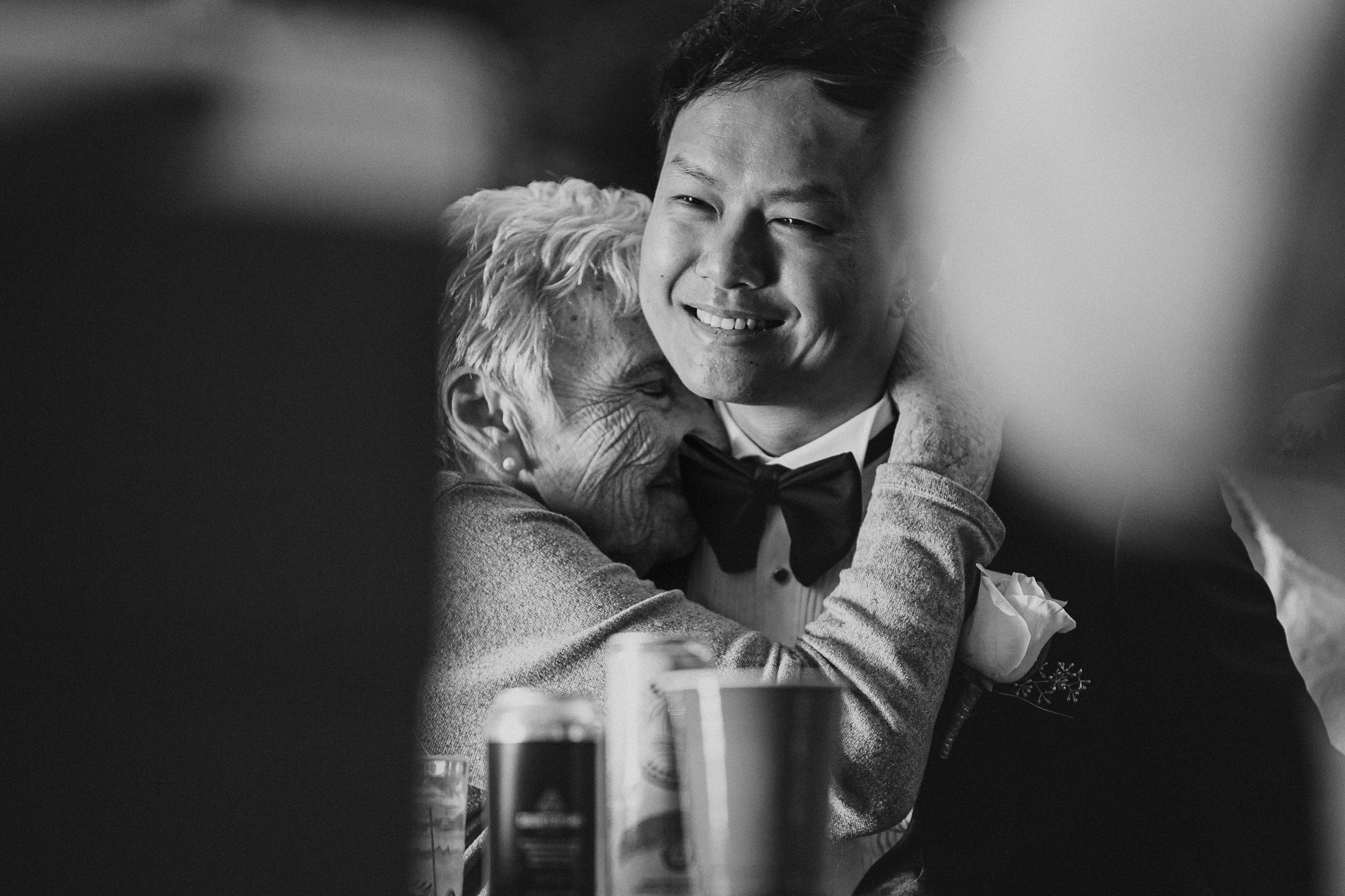 Intimate black and white moment during wedding celebrations.