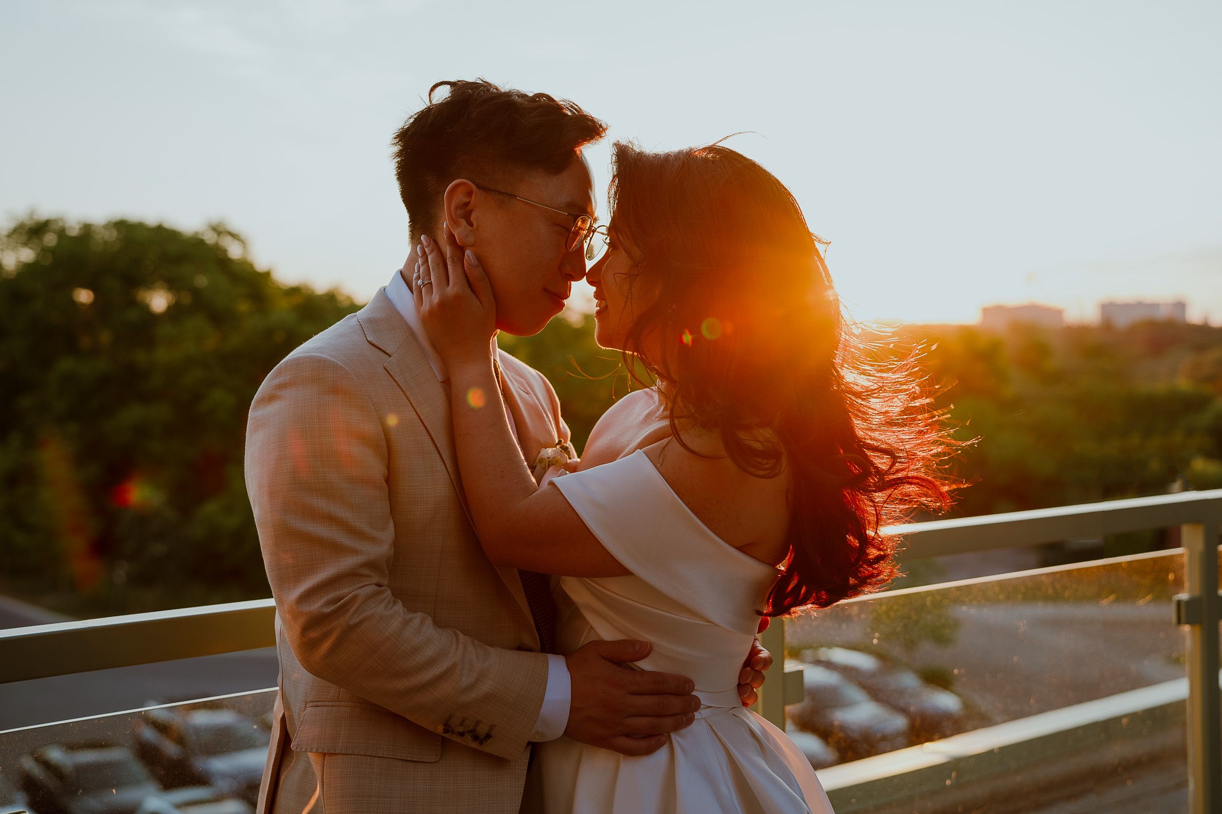 A romantic sunset moment captured on a rooftop with warm golden light.