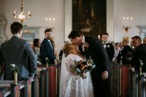 A couple shares their first kiss during a traditional church wedding ceremony.