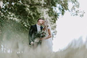 Intimate wedding portrait of a couple embracing in soft dreamy lighting.