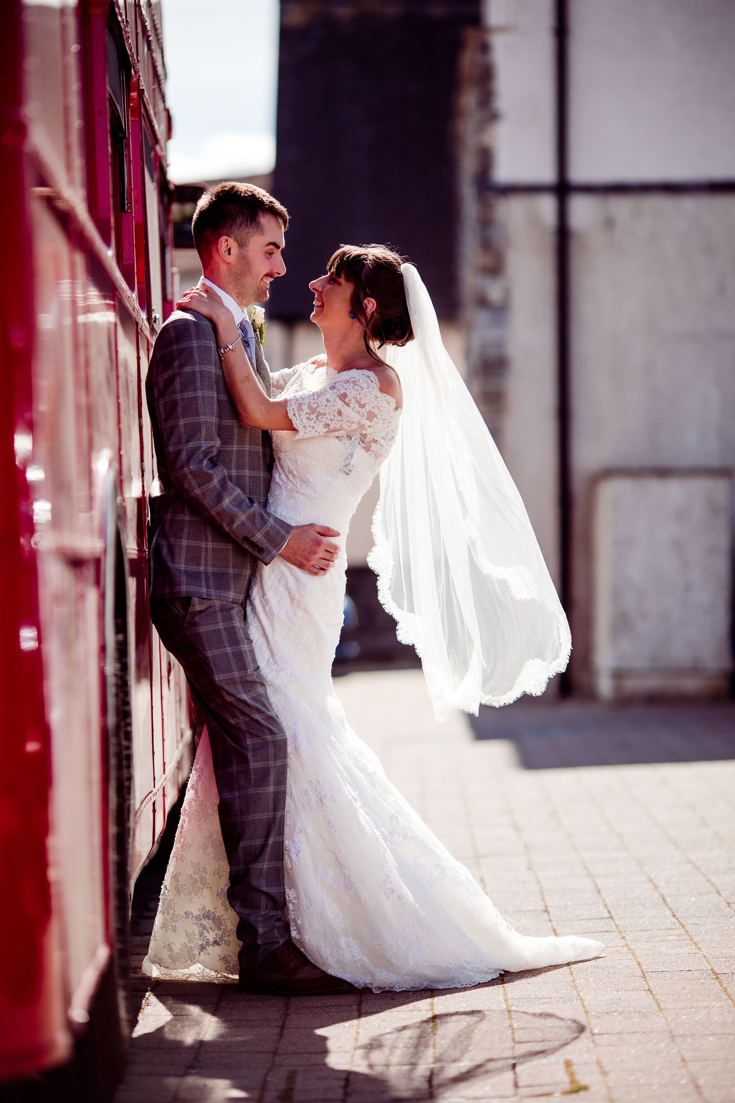 Bride and groom with red stagecoach London style bus