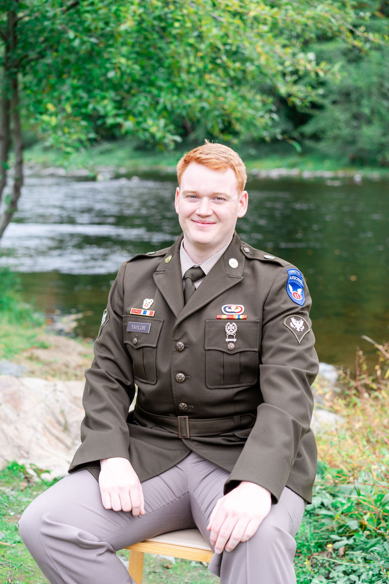 groom sitting by the river