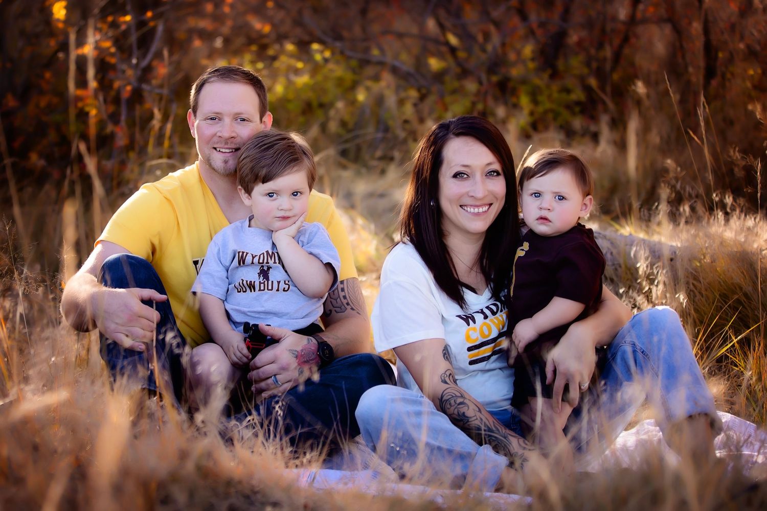 A warm sunset portrait session in a field with dried grass and autumn colors.