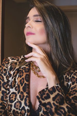 Fashion portraits featuring a model in a leopard print top with dramatic poses against a dark background.
