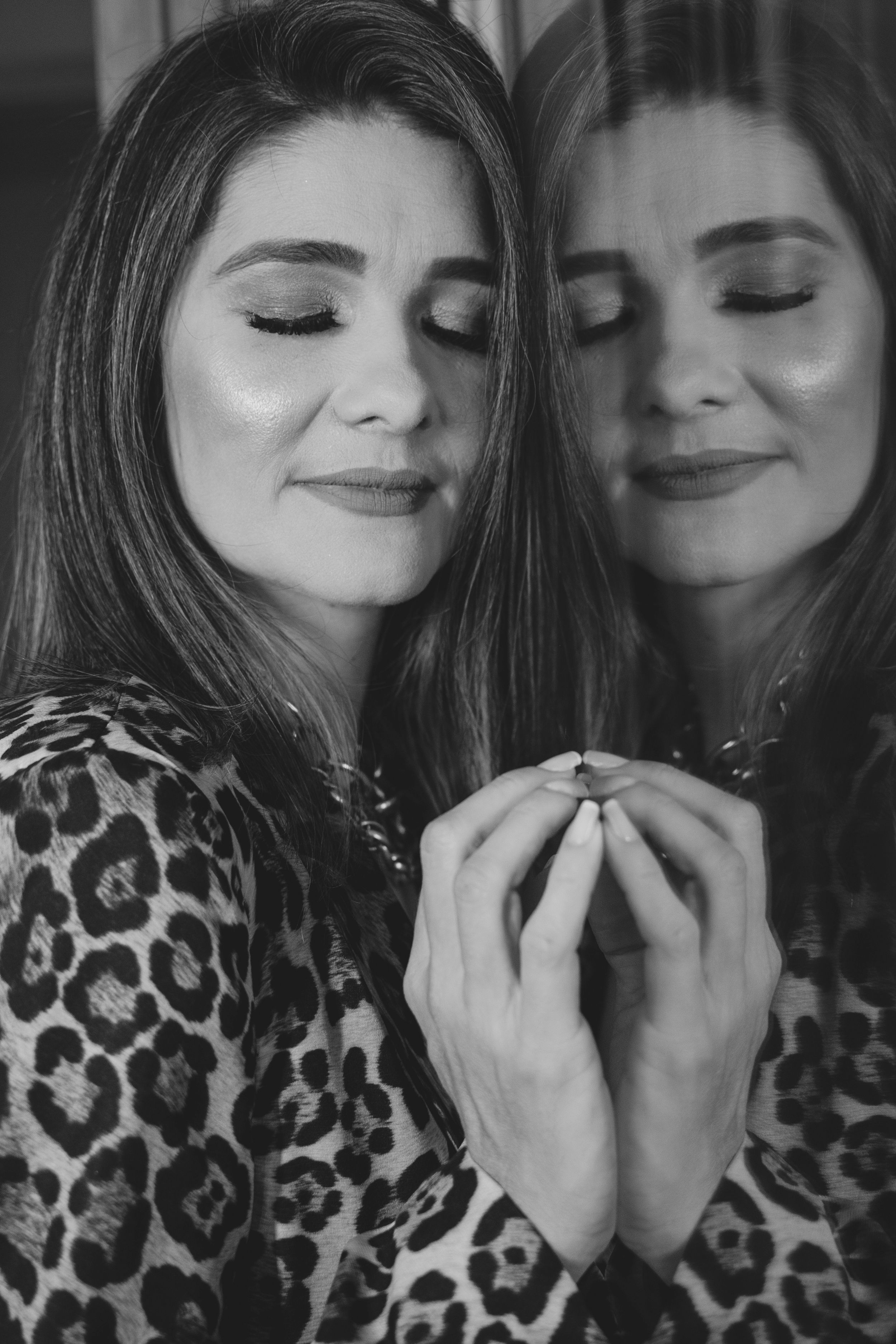 A series of black and white close-up photos showing playful expressions and leopard print clothing.