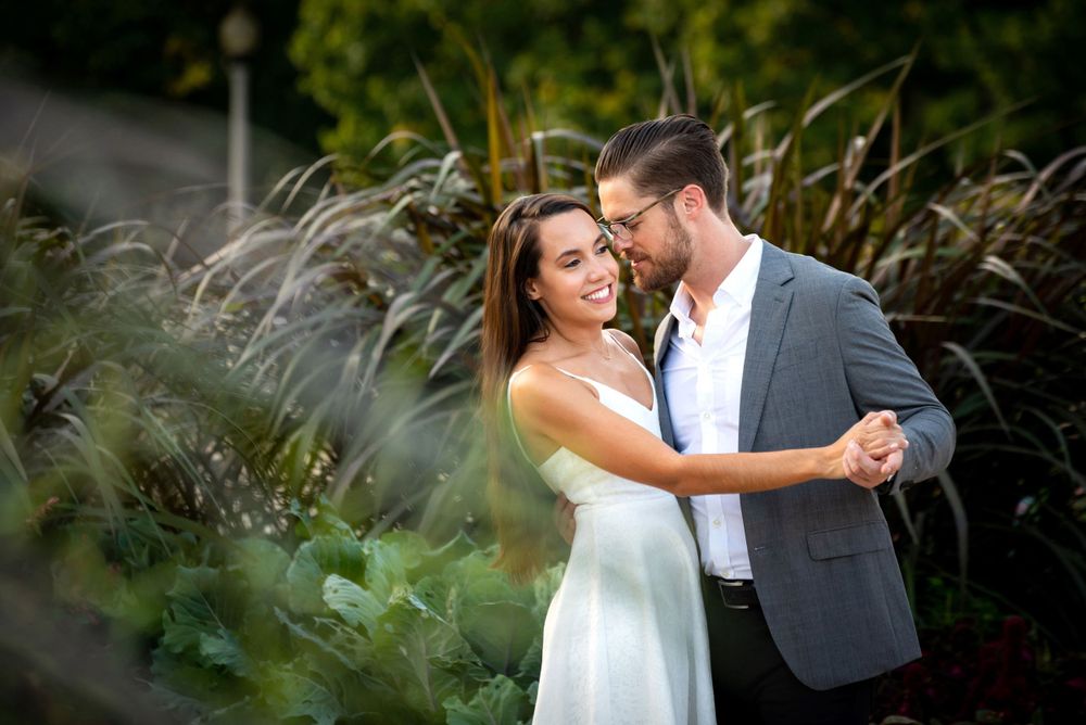 A recently engaged couple dancing in a garden at the Museum Campus in Chicago, iL