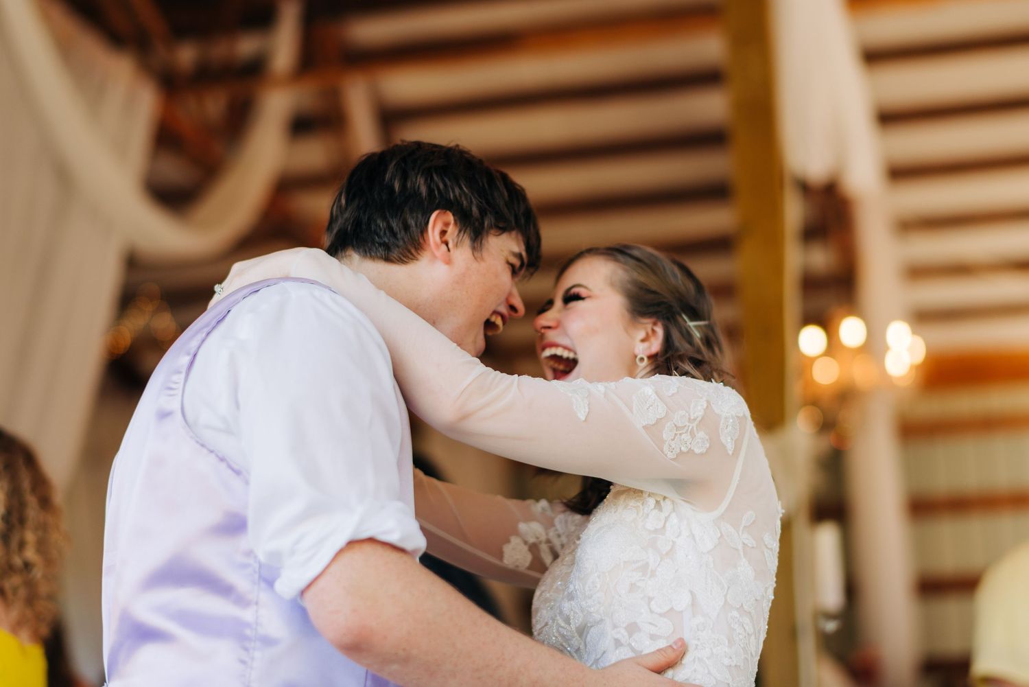 Bride & groom smiling during first dance barn wedding Newport, WA