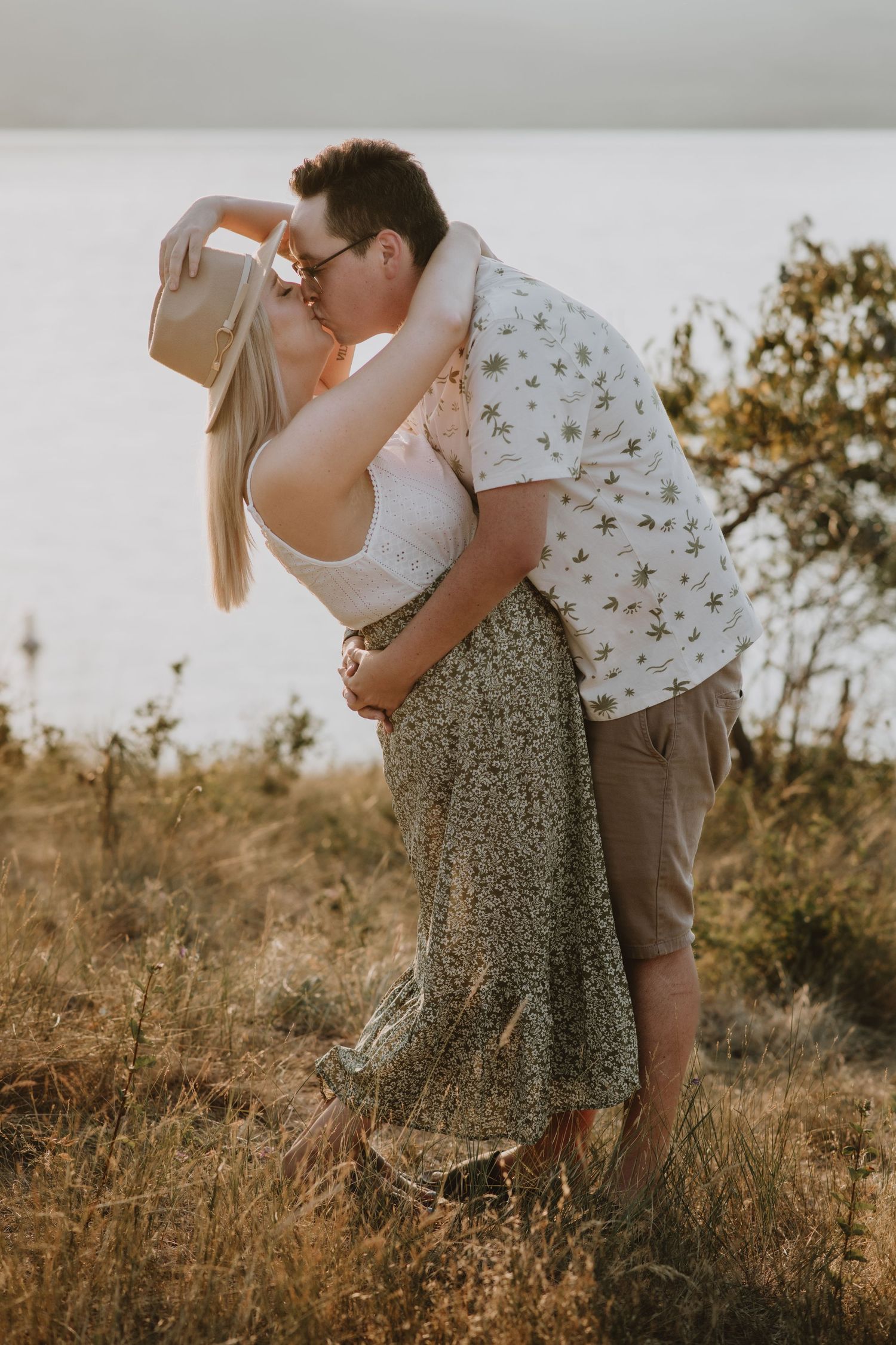 Couple kisses at sunset. Okanagan wedding photographer shares an engagement photo
