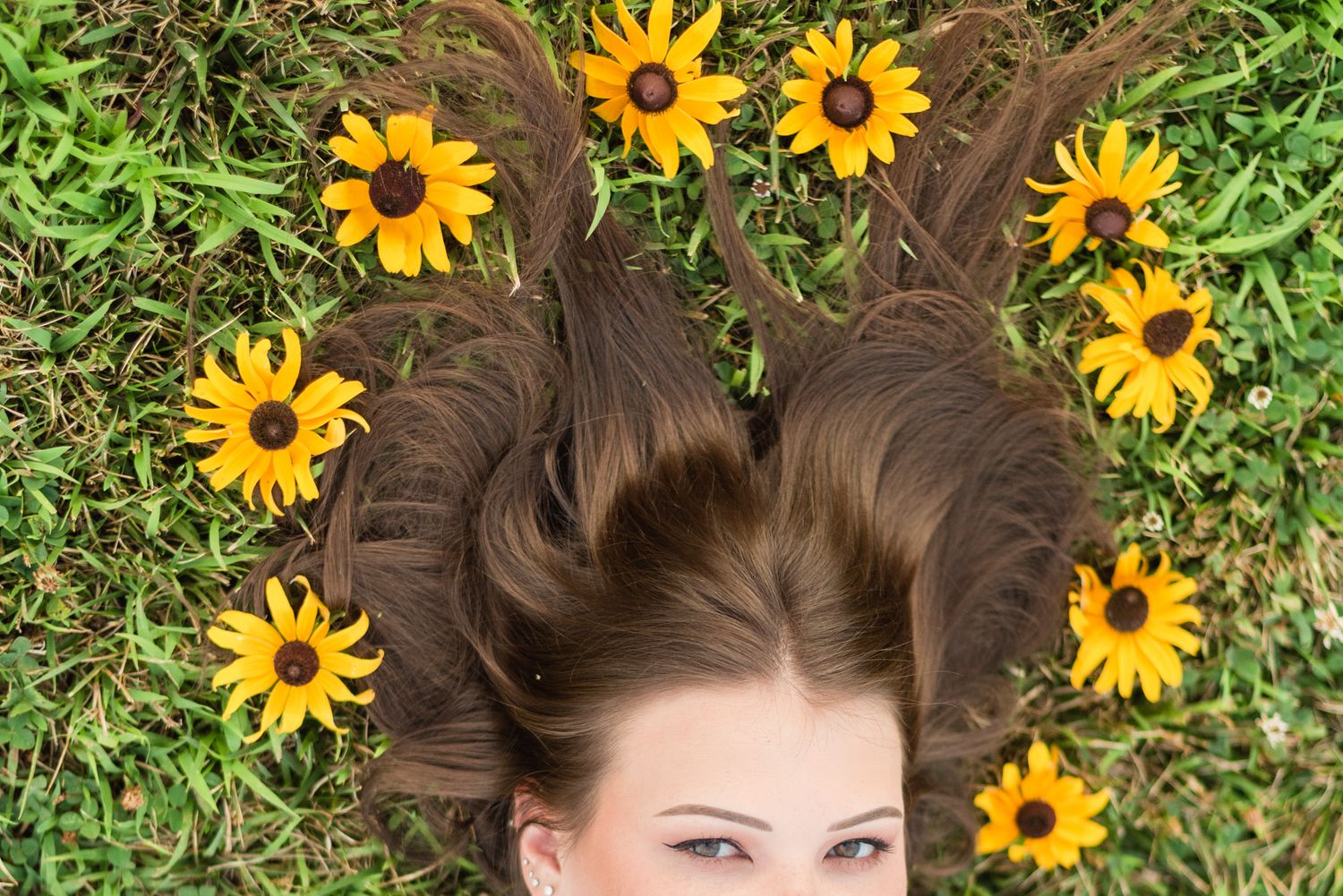High school senior with flowers in her hair in golden sunlight at Hartwood Acres in Pittsburgh Pennsylvania