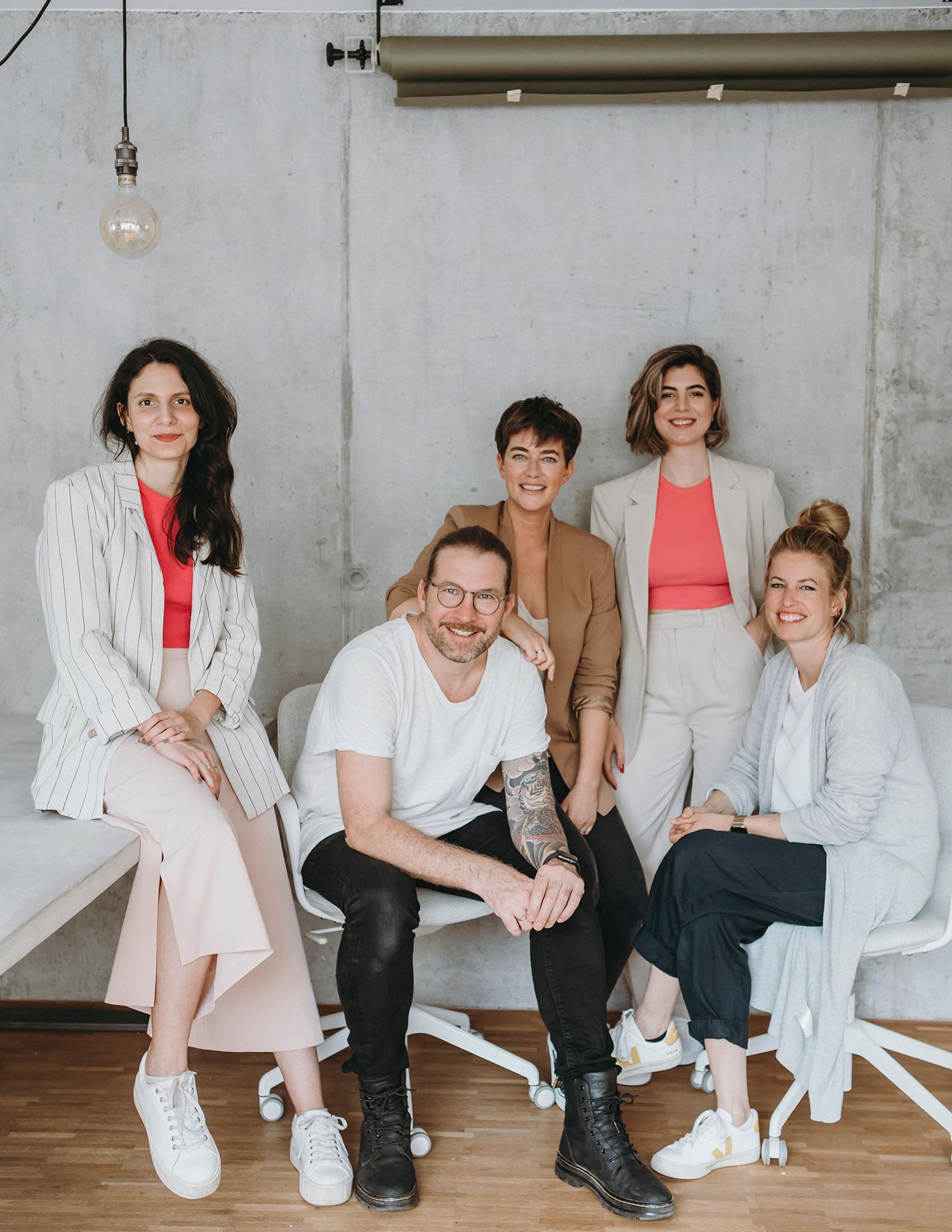 Group photo sequence of creative team members sitting casually in a modern office setting.