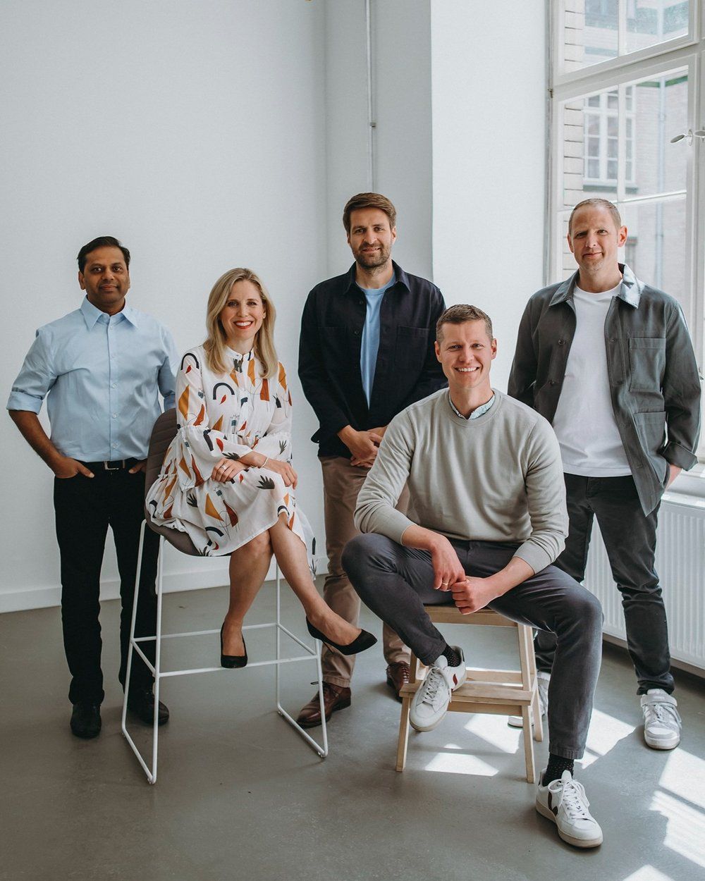 Casual group photo of diverse business team sitting together in modern office. Zolar Team photo