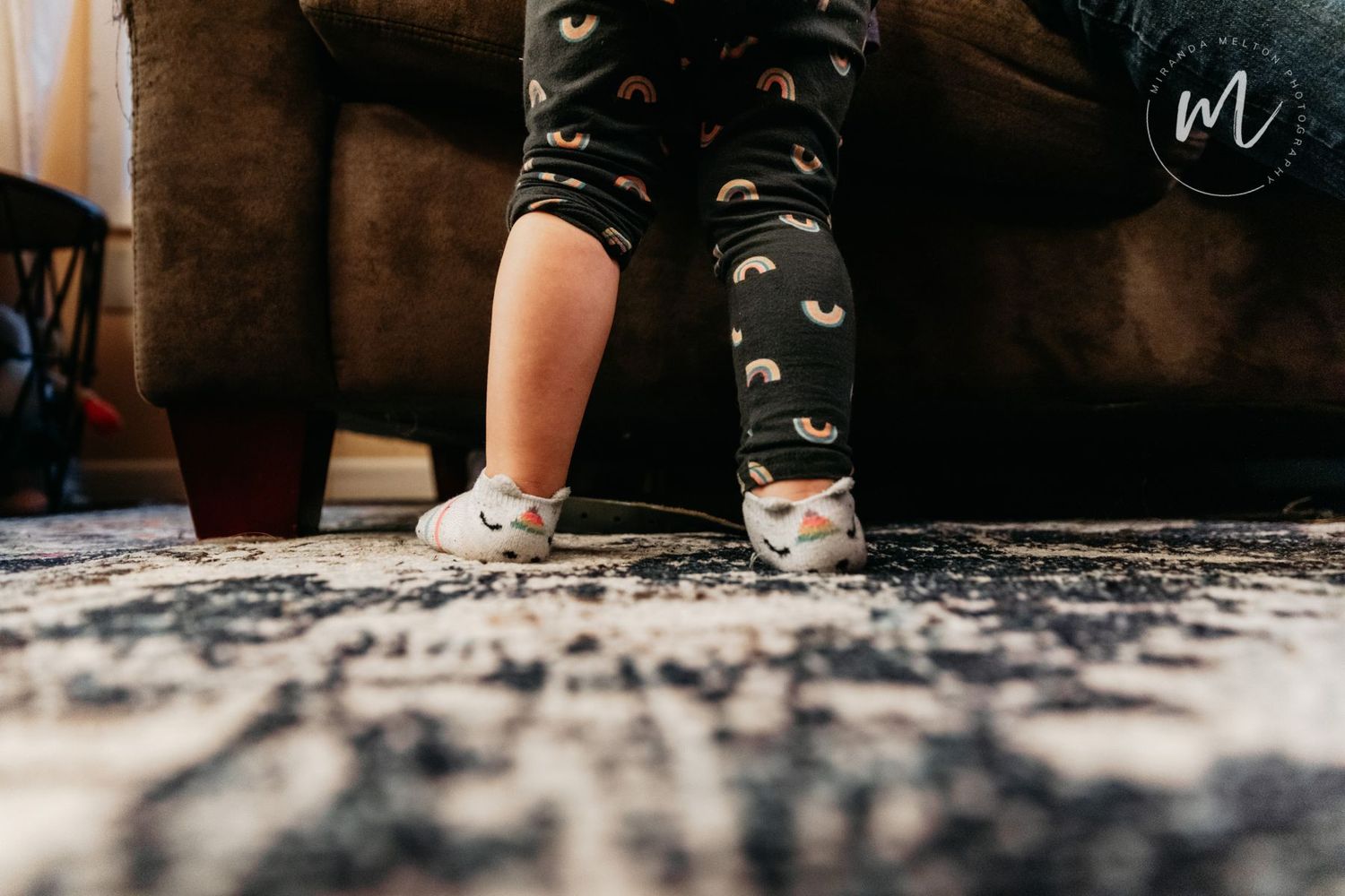 Professional photo detail of a toddler's rolled-up pant leg and unicorn socks highlights mindful parenting moments in the Twin Cities