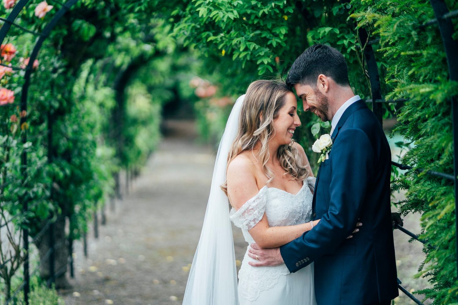 Intimate wedding moments captured in a lush garden setting with natural greenery.