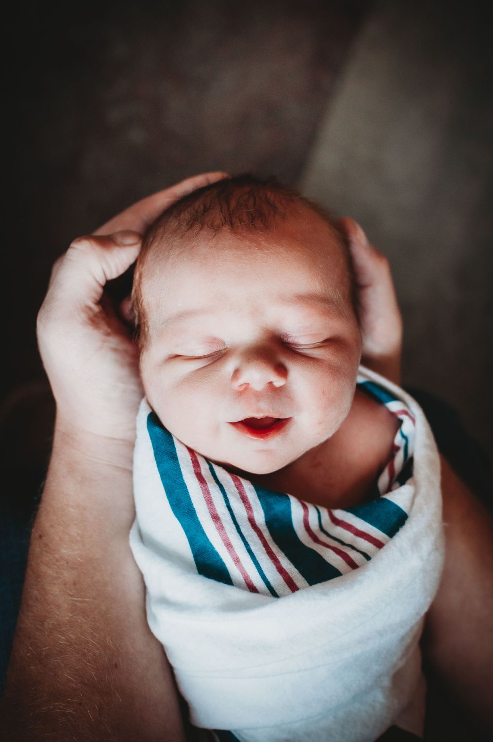 Newborn baby smile - natural light photographer in Dickinson, ND