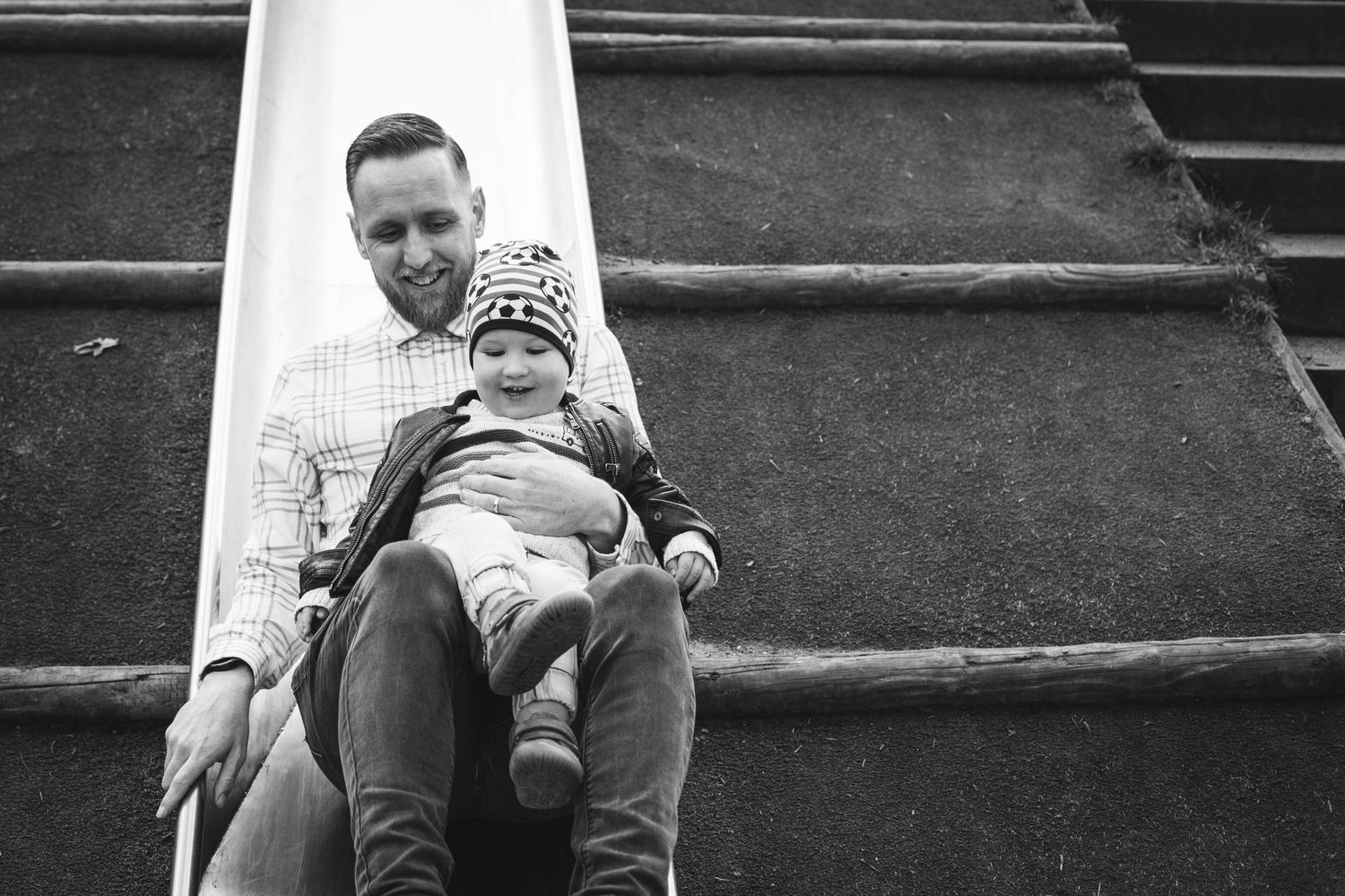 A playful moment on outdoor stairs in black and white photography.